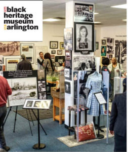 Photo of part of the Black Heritage Museum of Arlington, showing exhibits and people wailing around the museum.